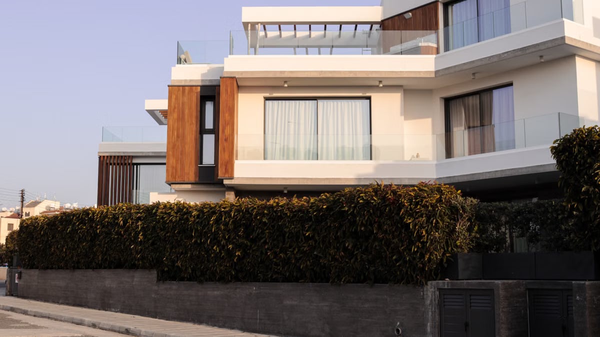 A contemporary luxury villa featuring minimalistic architecture and lush greenery.